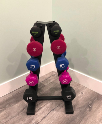 Reviewer's black dumbbell rack with red, blue, and pink weights