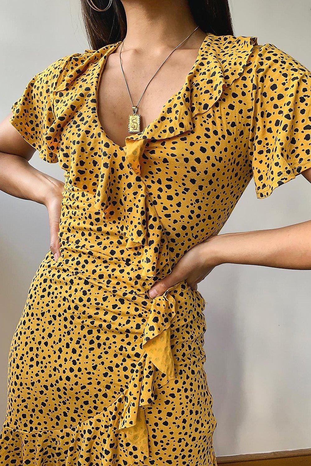 model wearing yellow and black Dalmatian print V-neck dress 