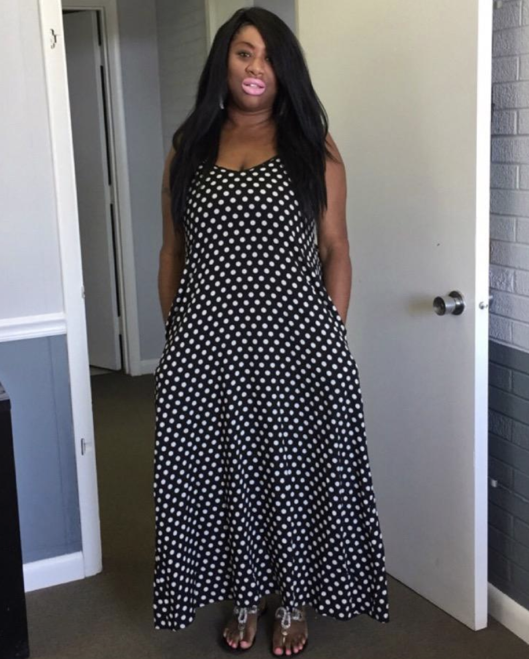 reviewer wearing navy and white dotted strapless maxi dress