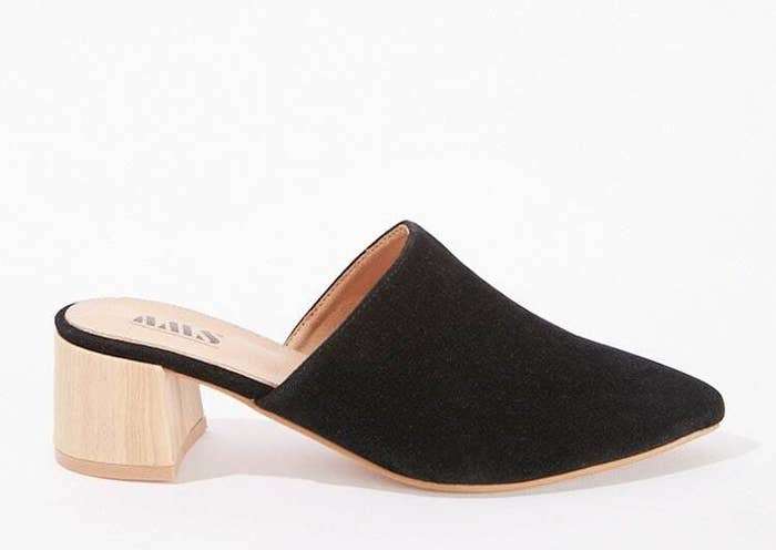 A black pointed toe mule with a faux wooden heal about two inches high 