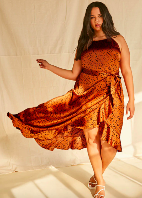 A model wearing the high-low dress in orange. 