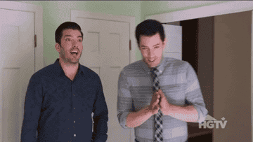 The Property Brothers clapping their hands together in excitement