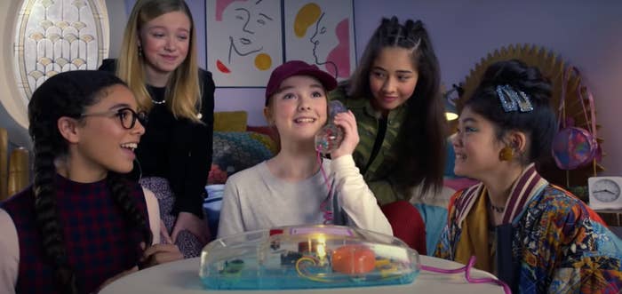 Mary-Anne, Stacey, Dawn, and Claudia watching Kristy answer the phone in The Baby-Sitter&#x27;s Club.