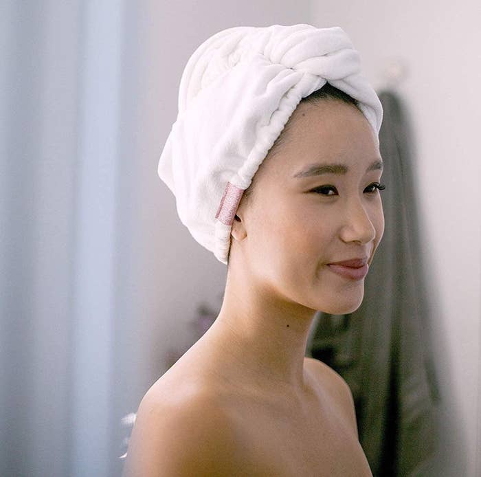 A person wearing a fluffy towel around their head