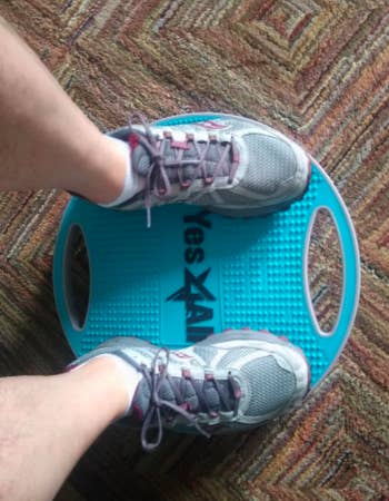 Reviewer uses blue wobble balance board to workout in their home