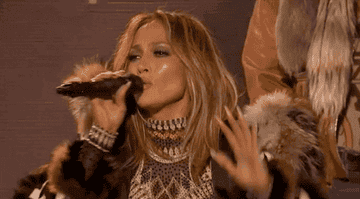 Jennifer Lopez holds her hand up during a performance, gesturing for people &#x27;to wait&#x27;