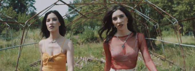 The Veronicas standing in a field, walking towards the camera