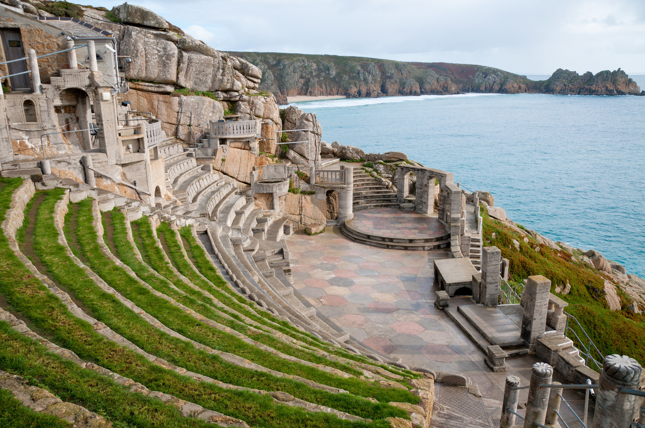 The outside theatre made from stone is perched on a cliff – you can see the cliffs of Cornwall in the background with the sea below