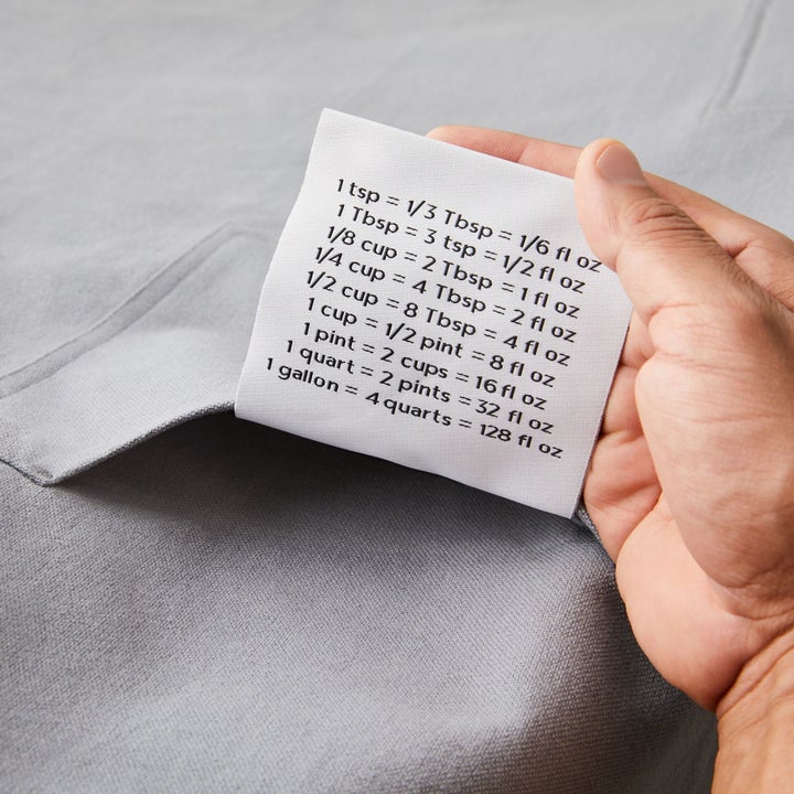 the large conversion chart tag in a grey apron's pocket