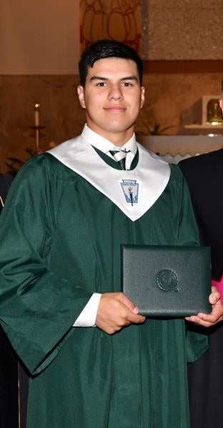 Daniel Anderl is pictured wearing graduation robes, smiling, looking at the camera.