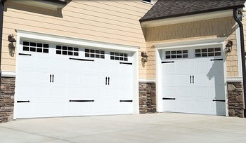 The black magnets on white garage doors