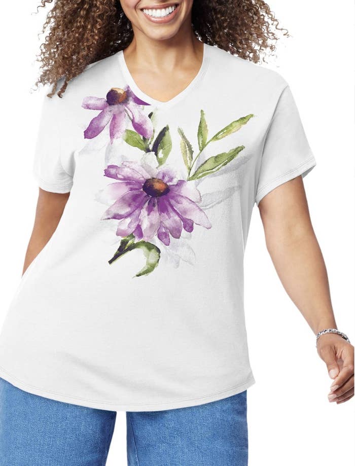 A model in a white t-shirt with a purple flower watercolor