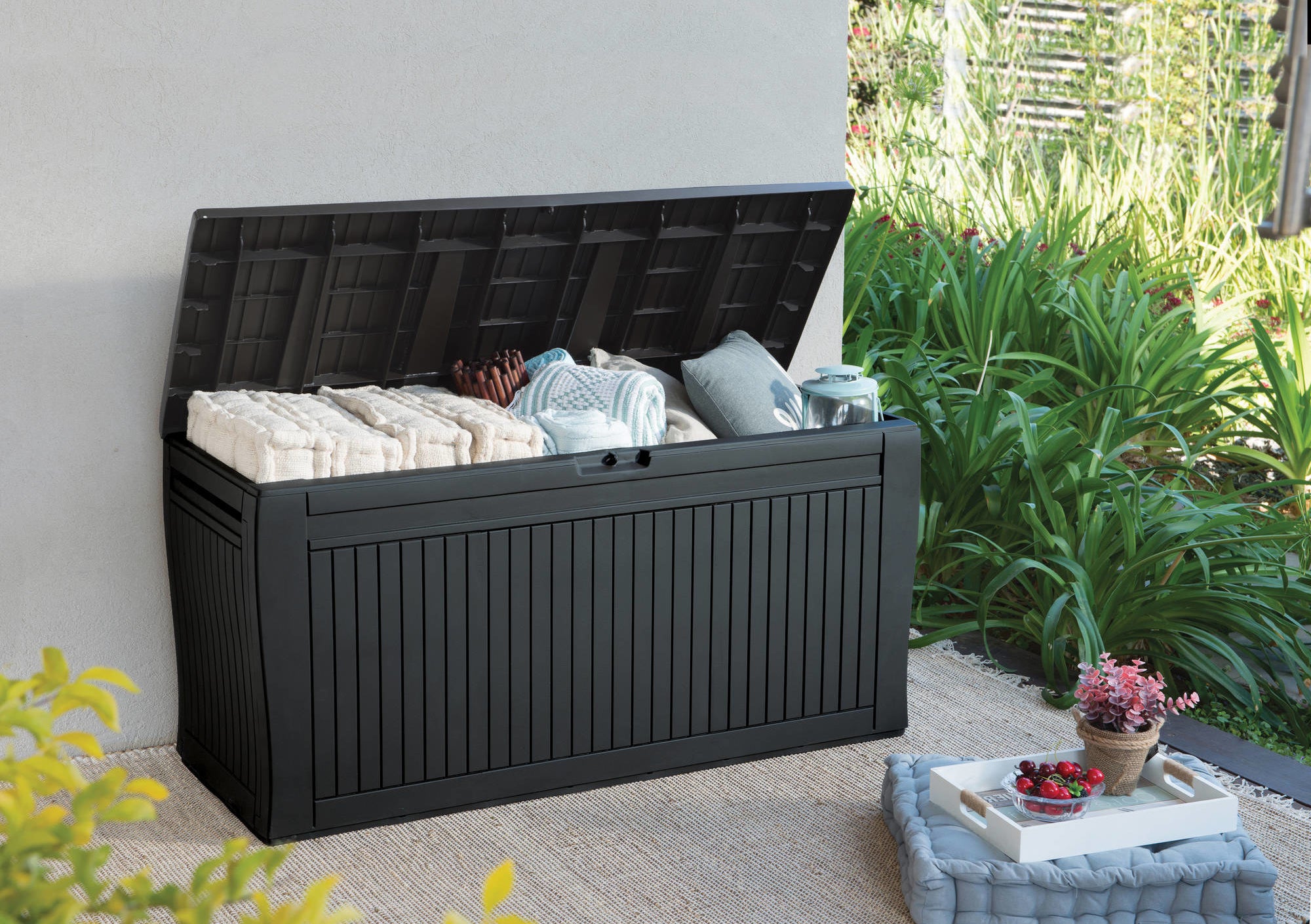 An espresso brown outdoor storage box with the lid open