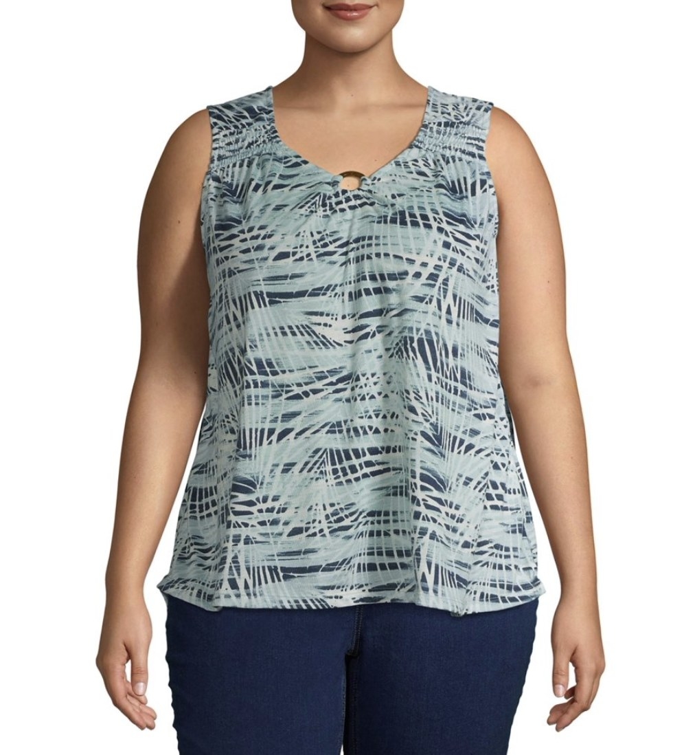 A model in a blue palm leaf-print sleeveless top 