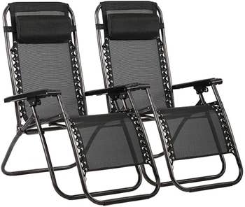 a pair of black lounge chairs with a headrest attached