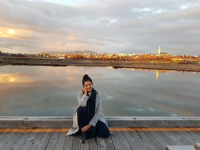 A woman sitting on a boardwalk