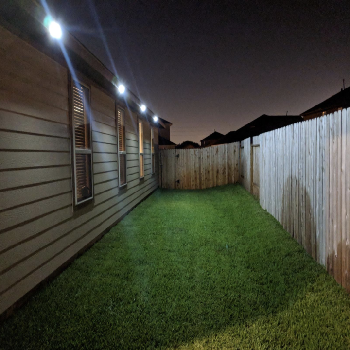 the four lights brightly shining in a backyard at night