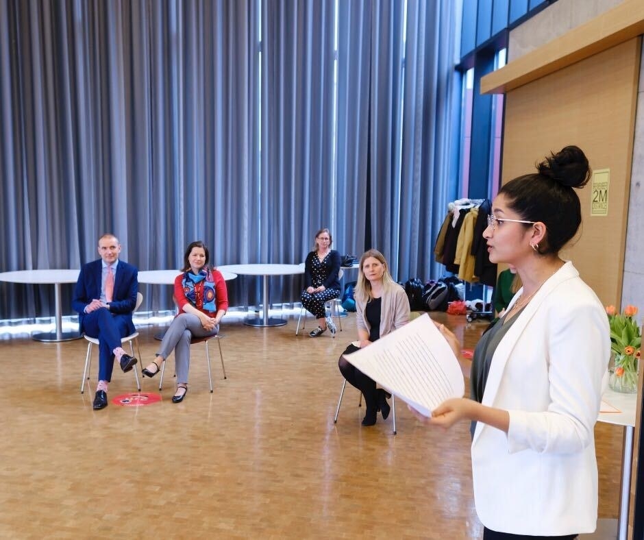 A woman talks to a group of people