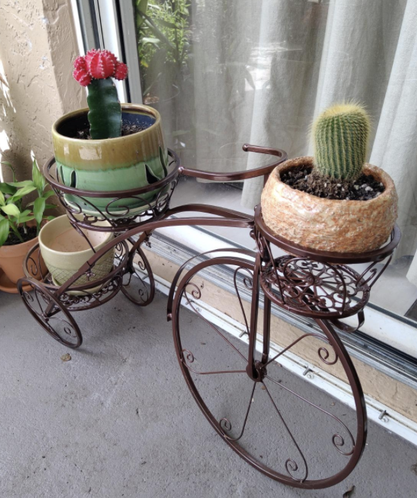 a bronze planter shaped like a bicycle