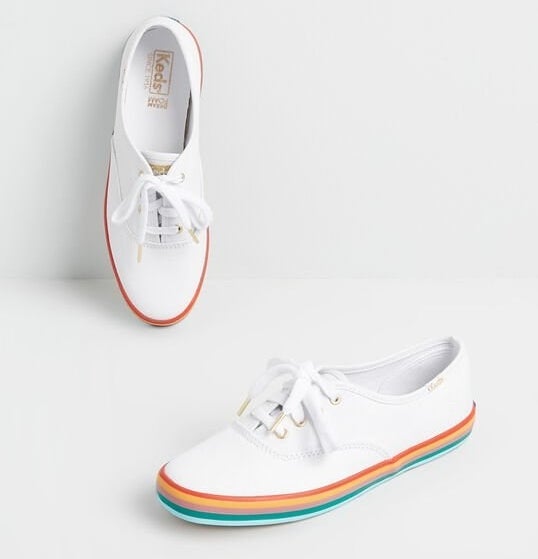 The with lace-up sneakers with red, yellow, pink, teal, and light blue striped bottoms