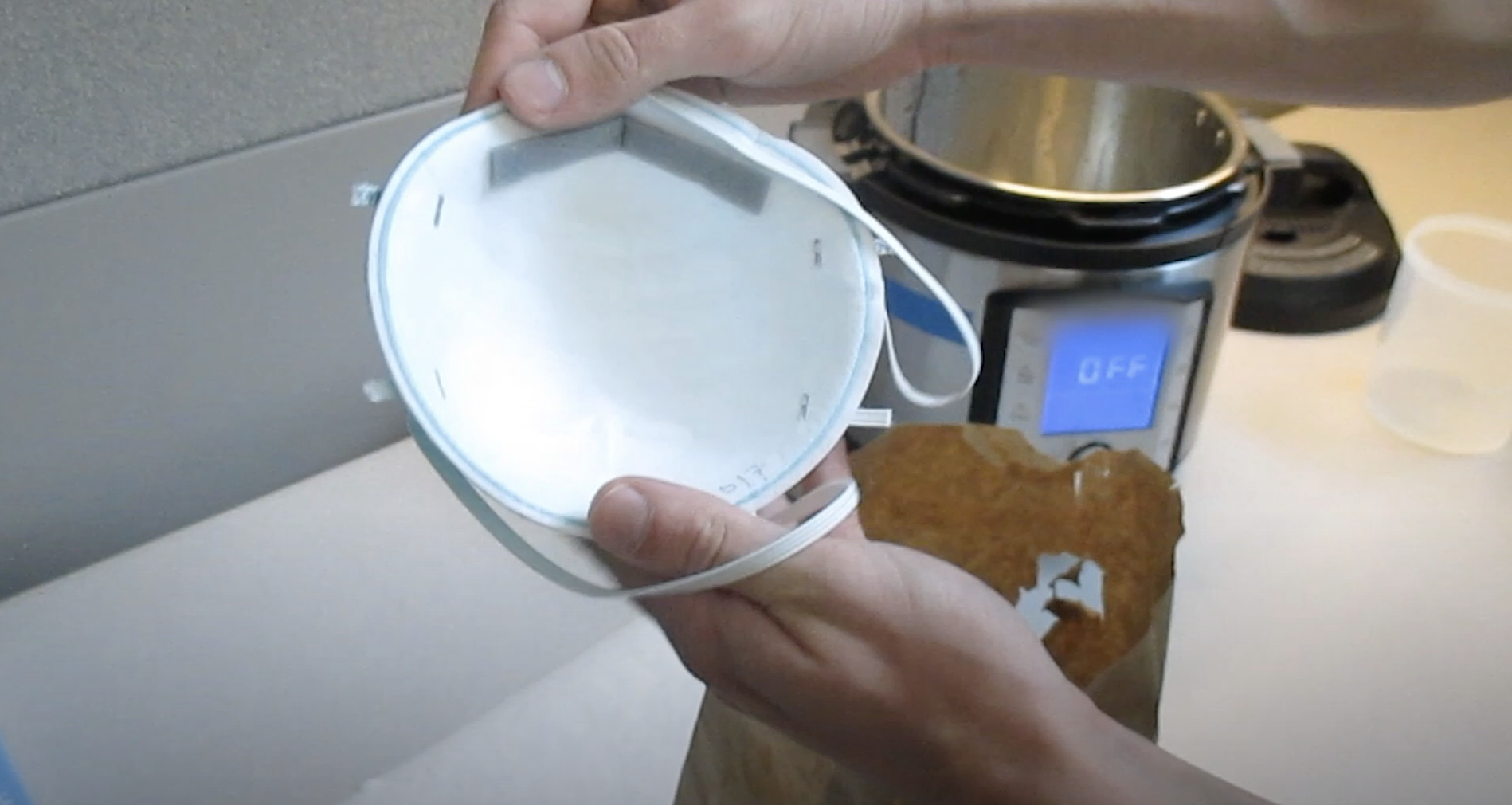 Photo of a decontaminated mask being taken out of the Instant Pot