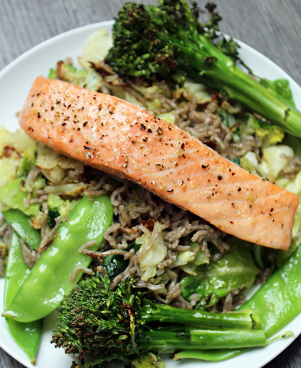 Trader Joe&#x27;s soba noodle stir-fry with a piece of salmon and some charred broccolini.