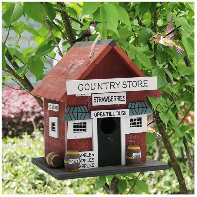 the red birdhouse with a sign that says 