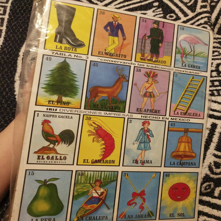 a card with different pictures in each square. Each picture has its Spanish word at the bottom like "Ell Gallo" for rooster 