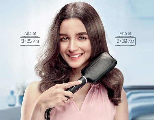 Bollywood actress, Alia Bhatt, using the straightening tool to style her hair