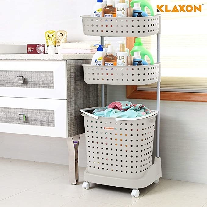 Grey storage basket with two storage compartments and a lower laundry basket.