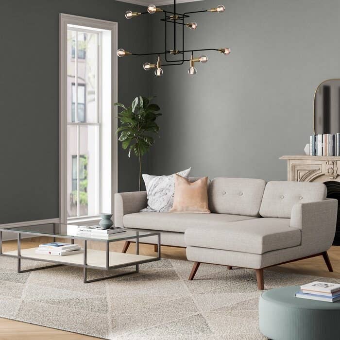 Sectional in venga mole light gray with tufted cushions and wooden mid-century style legs
