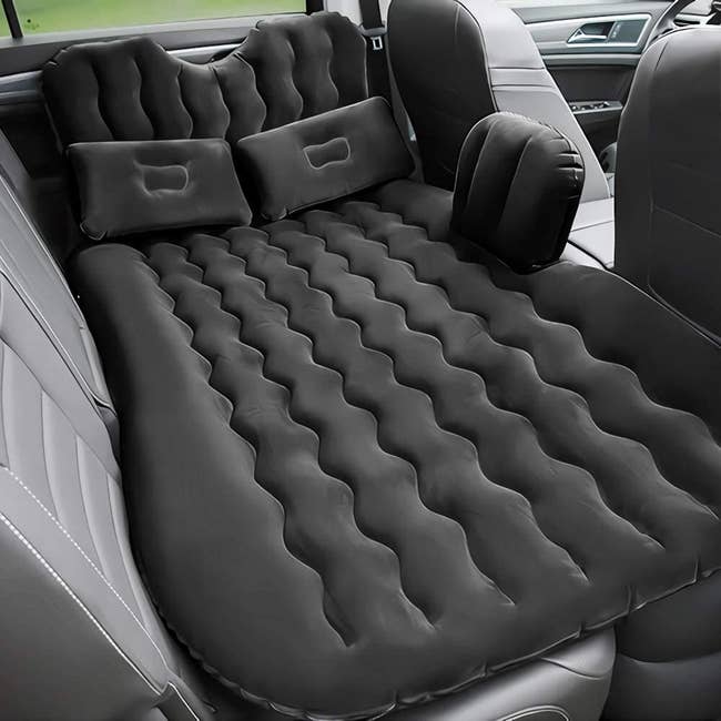 The air mattress laid out in a car back seat