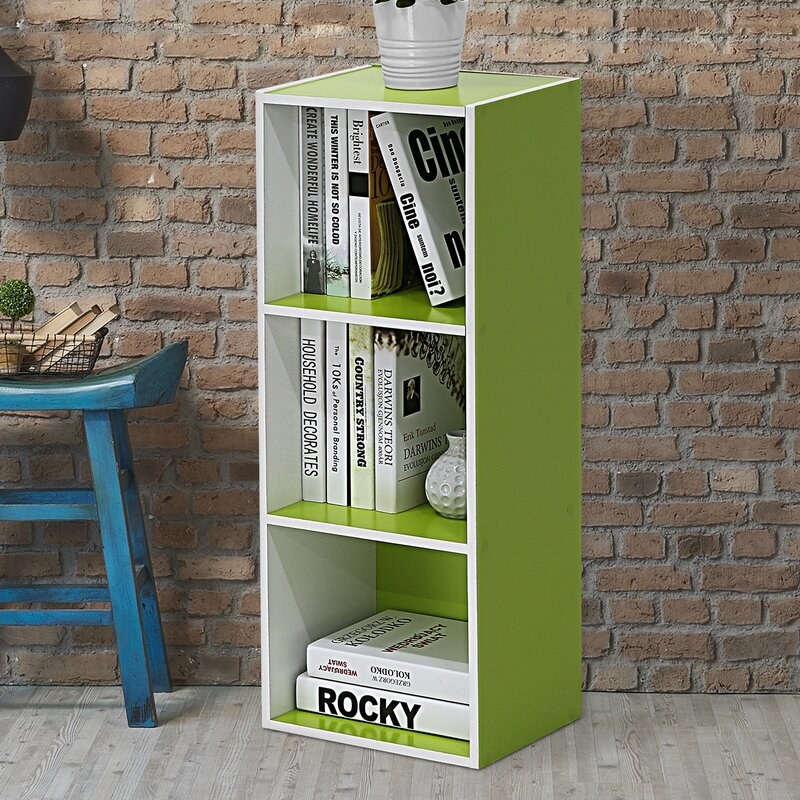 A bright lime green floor-standing bookcase with three shelves