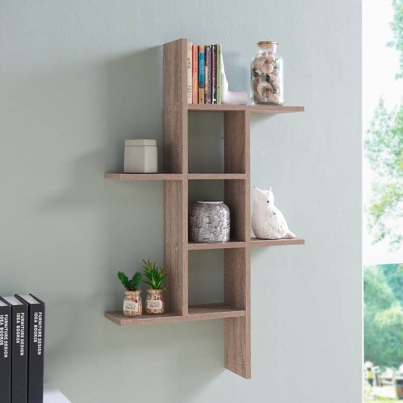 A weathered oak wall-mounted shelf for small items 