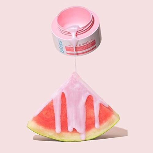 A jar of the product being dripped onto a slice of watermelon 