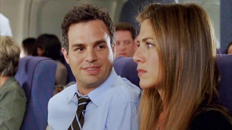 Jeff is looking at Sarah lovingly while sitting next to her on the airplane; Sarah is visibly anxious about visiting her family in California