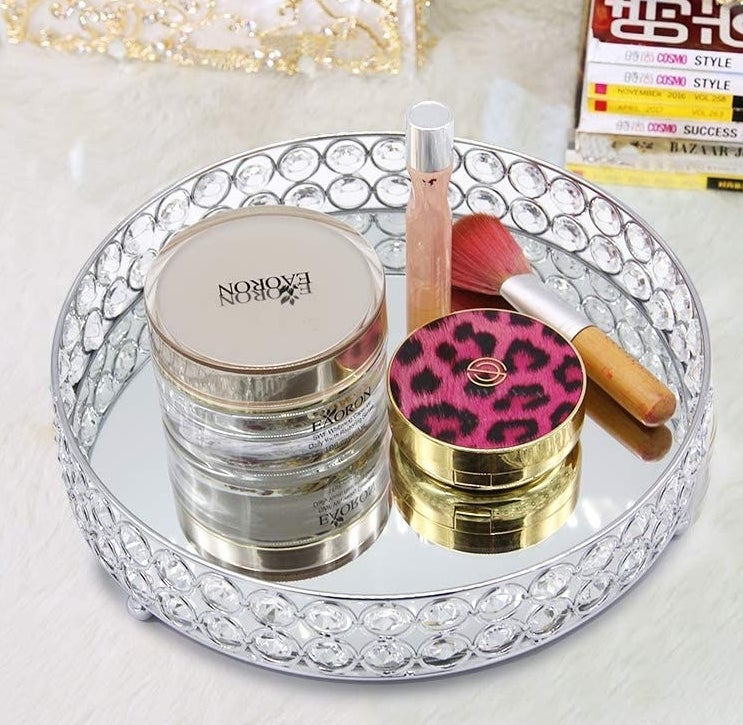 The crystal tray with beauty products on top of it