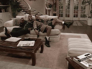 A GIF of Carlton and Will from The Fresh Prince of Bel Air sitting on a couch