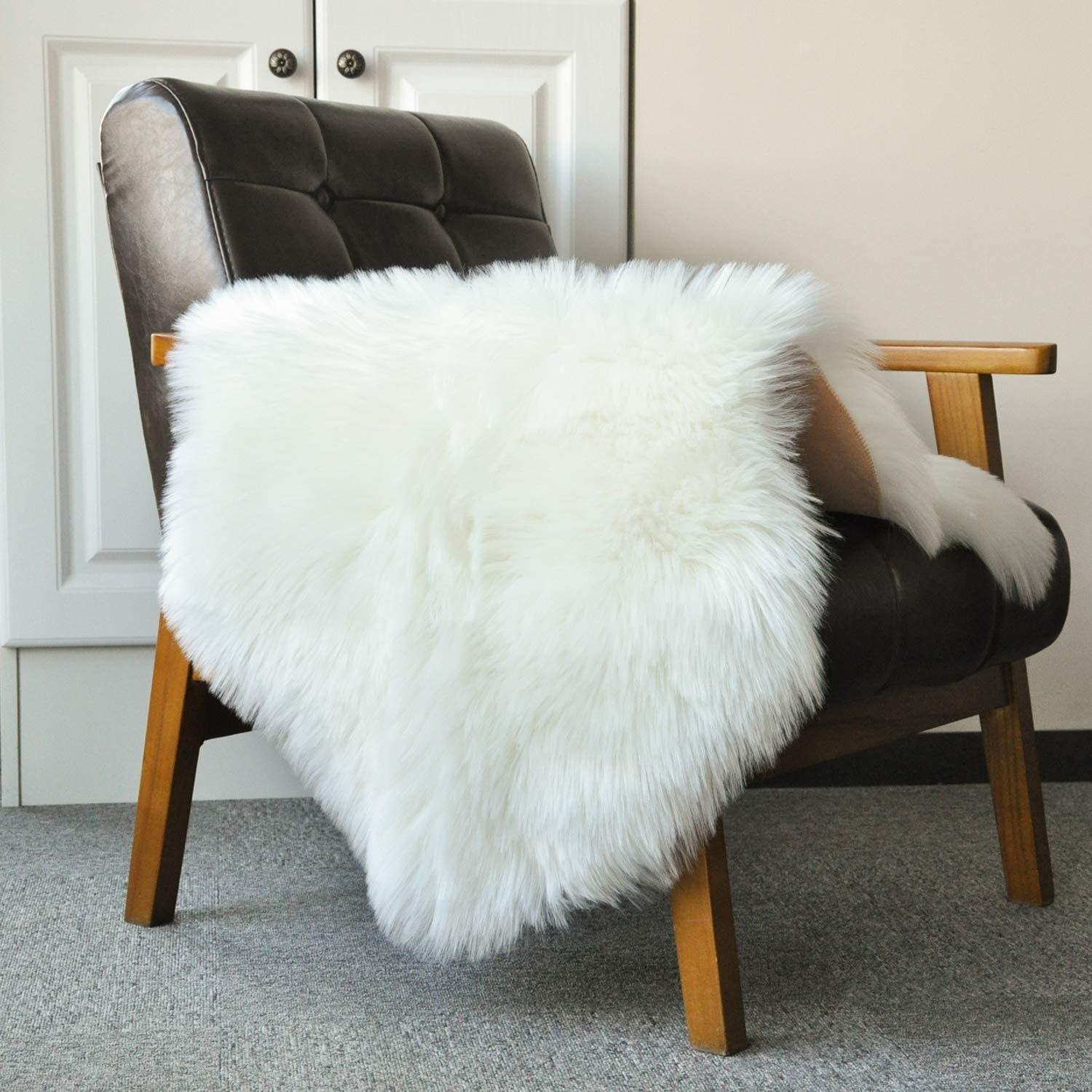 A faux sheepskin rug on a chair