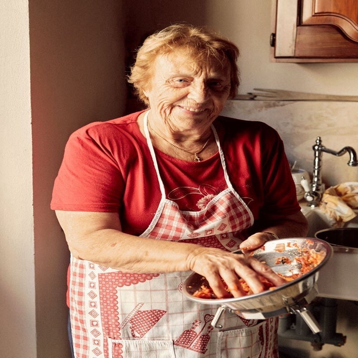 A grandma mixing in the kitchen