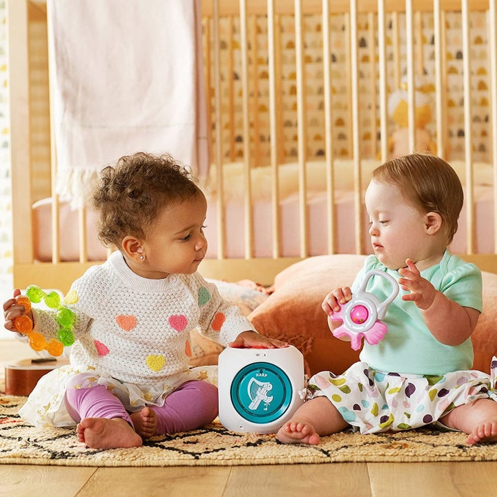 two toddlers playing with musical cube