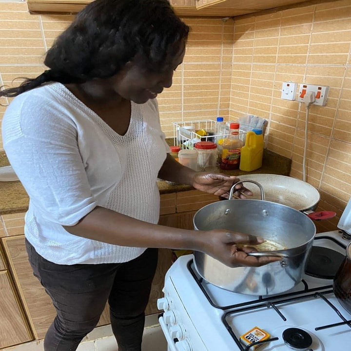 Josephine, the host, lifting a pot from the stove