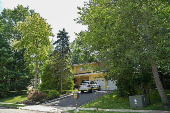 The home of Judge Esther Salas in New Jersey is seen with police tape around it and large trees that surround the property.