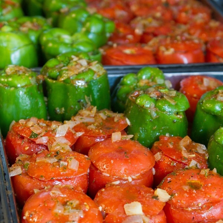tray of tomatoes and green peppers stuffed with rice
