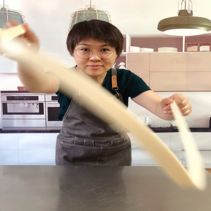 Woman pulling noodles 
