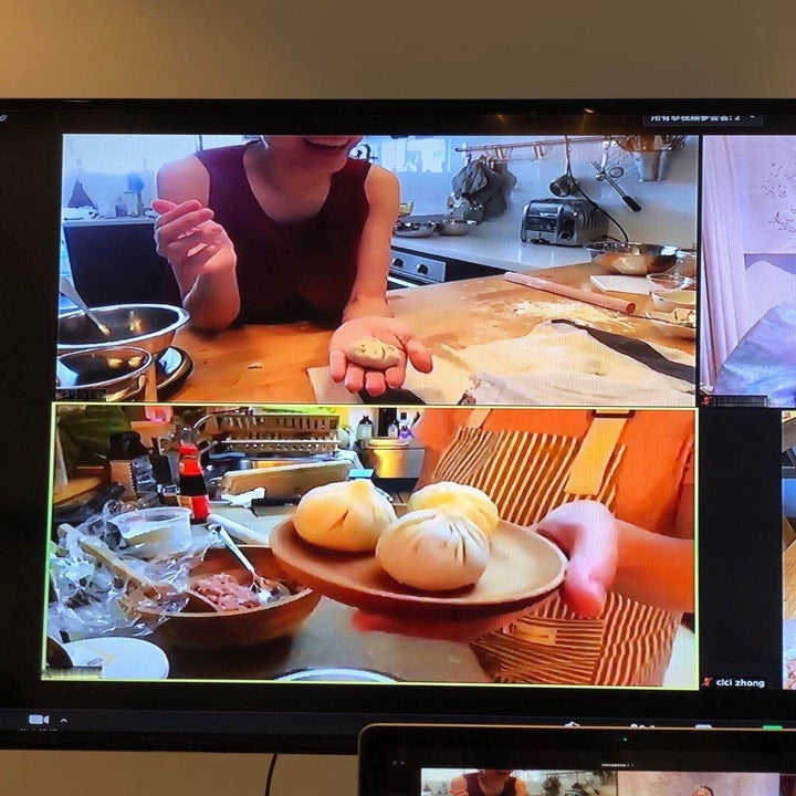 tv with a split screen showing two cooking students making dumplings int their home kitchens