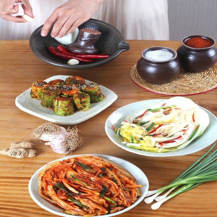 small plates of Korean food, including cabbage salad and kimchi 