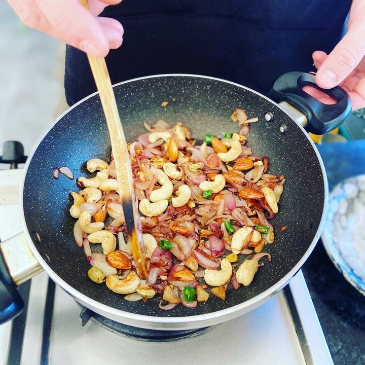 Cashews and vegetables cooking in a frypan 