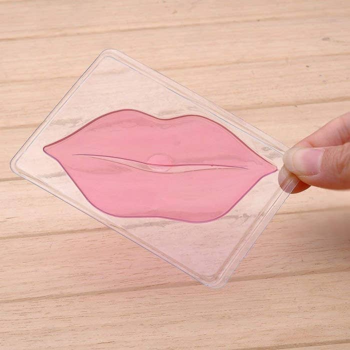 A person holding the lip mask up
