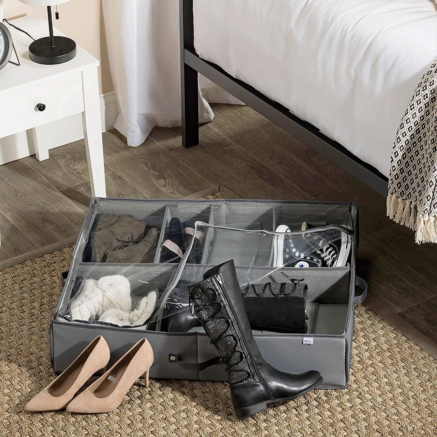 A large fabric container on the floor filled with shoes